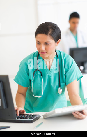 USA, New Jersey, Jersey City, Doctors working on computers Stock Photo