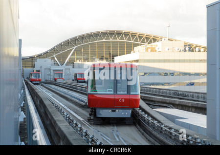 Trackless airport inter-terminal train, travelling to and from the arrivals / departures gates. Stock Photo