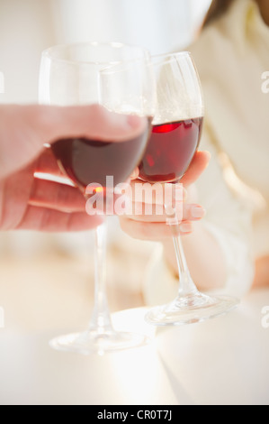 USA, New Jersey, Jersey City, Close up of man's and woman's hands making toast with red wine Stock Photo