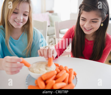 USA, New Jersey, Jersey City,  Two girls eating carrots