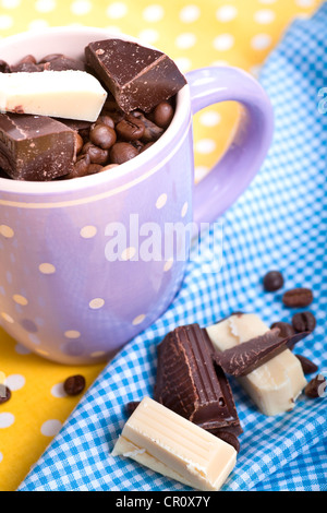 Cup with coffee beans and chocolate Stock Photo