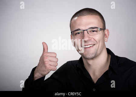 Young man, thumb-up gesture Stock Photo