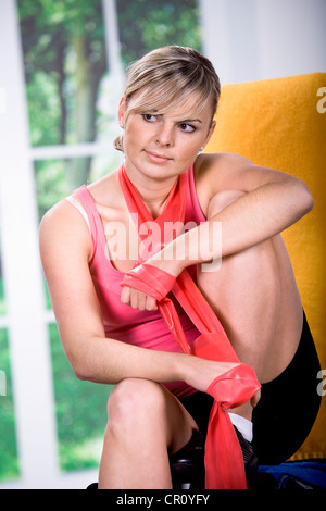 Young woman with rubber strap for exercising Stock Photo