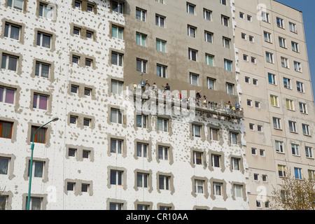 Workers attaching insulation to a block of flats in Poland, Europe Stock Photo