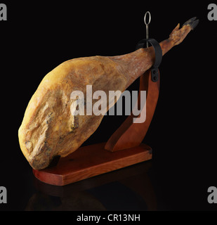 Spanish cured dried Iberico ham hanging on a rack in a supermarket ...