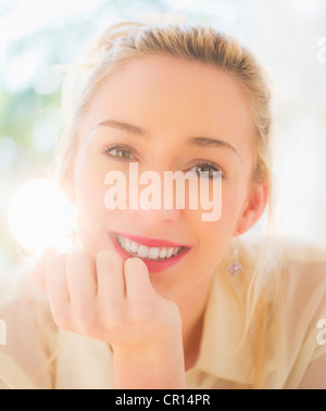 USA, New Jersey, Jersey City, Portrait of smiling young woman with blonde hair Stock Photo