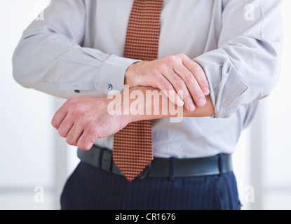 Man rolling up sleeves Stock Photo