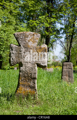 Cross on the prehistorical grave in forest Stock Photo