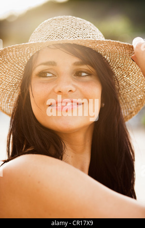 Smiling woman wearing sunhat Stock Photo