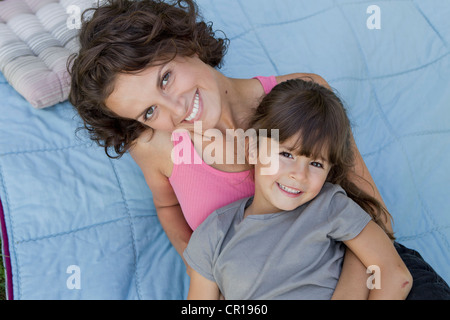 Mother and daughter relaxing on blanket Stock Photo