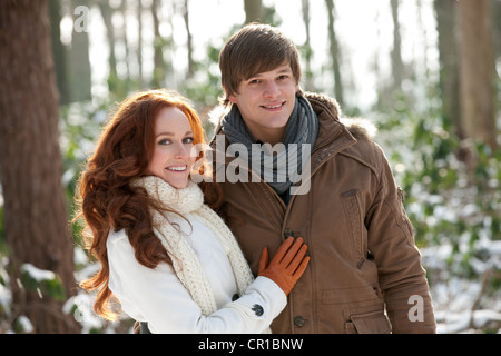 Netherlands, North-Brabant, Hilvarenbeek, Young couple embracing in winter scenery Stock Photo