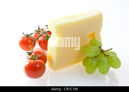 Emmental cheese with grapes and tomatoes Stock Photo