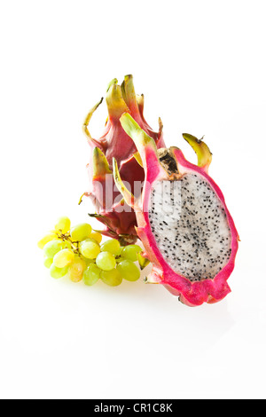 Red pitaya or dragon fruit (Hylocereus undatus) with white grapes Stock Photo
