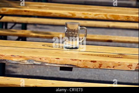 Empty beer mug on a table in a beer garden Stock Photo