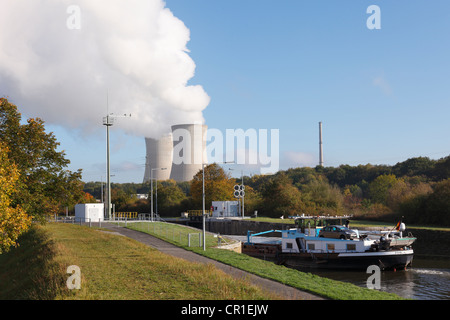 Cargo ship on the Main River in the Garstadt Lock, in front of the cooling towers of Grafenrheinfeld Nuclear Power Plant near Stock Photo