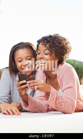 Mother and daughter using cell phone Stock Photo