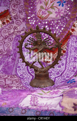 Bronze Shiva  Rajasthani textile backdrop made from saris.  Nataraja (Sanskrit: Lord of Dance) Shiva represe Stock Photo