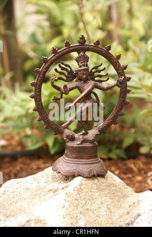 Bronze Shiva  Rajasthani textile backdrop made from saris.  Nataraja (Sanskrit: Lord of Dance) Shiva represe Stock Photo