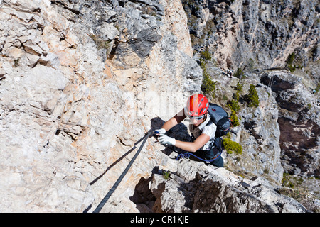 Climber climbing on the Stevia fixed rope route, Langental valley near Wolkenstein, Selva, province of Bolzano-Bozen, Italy Stock Photo