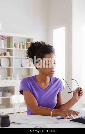 USA, California, Los Angeles, Young woman using calculator Stock Photo