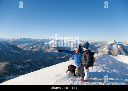 Father and son surveying snowy landscape Stock Photo