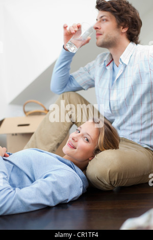 Couple relaxing together on floor Stock Photo