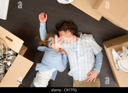 Couple laying together on floor Stock Photo