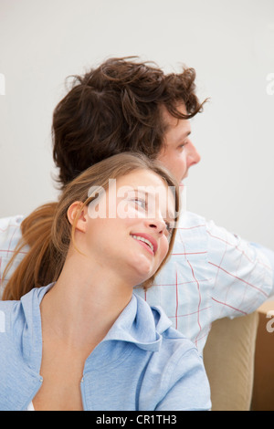 Couple standing back-to-back Stock Photo