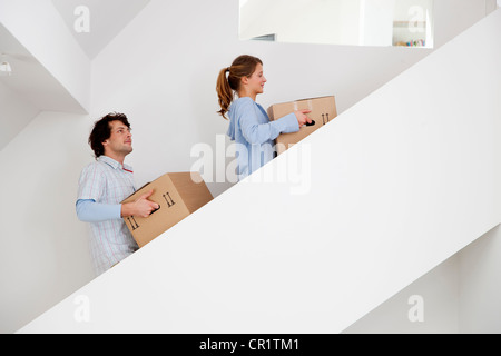 Couple carrying cardboard boxes Stock Photo