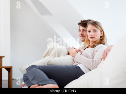 Couple relaxing together on sofa Stock Photo