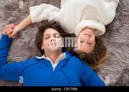 Couple relaxing together on rug Stock Photo