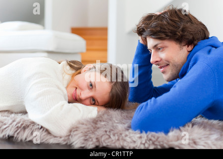 Couple relaxing together on rug Stock Photo