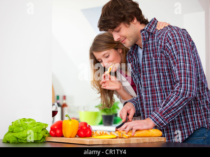 Couple cooking together in kitchen Stock Photo