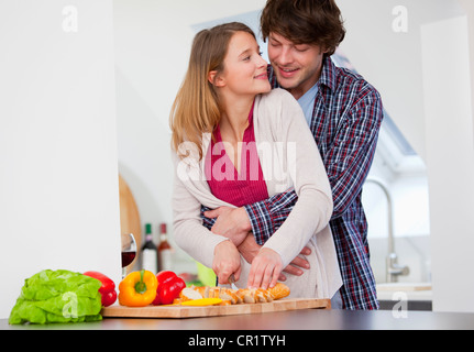 Couple cooking together in kitchen Stock Photo