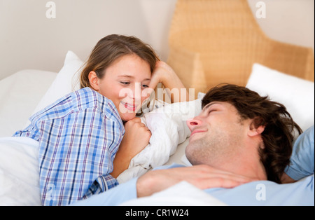 Smiling couple relaxing in bed Stock Photo