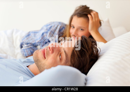 Smiling couple relaxing in bed Stock Photo