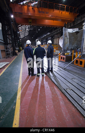 Workers talking in steel forge Stock Photo