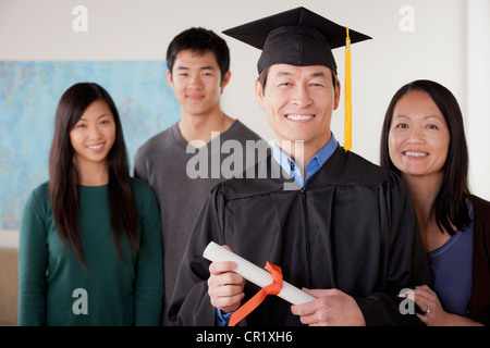 USA, California, Los Angeles, Portrait of mature man in graduation gown with family Stock Photo