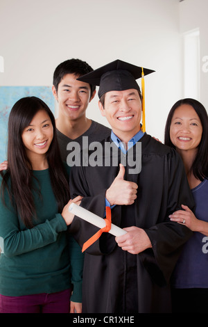 USA, California, Los Angeles, Portrait of mature man in graduation gown with family Stock Photo