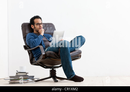 Smiling man using tablet computer Stock Photo