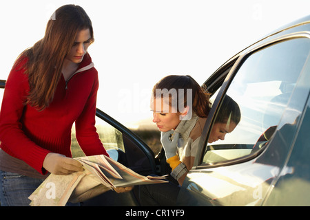 Women reading map together in car Stock Photo