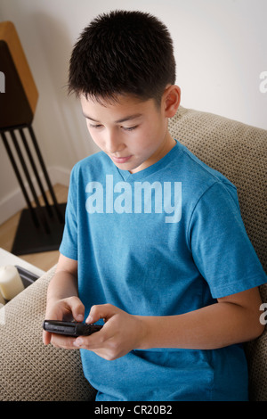 USA, California, Los Angeles, Boy (10-11) using mobile phone Stock Photo