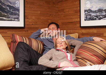 Couple sleeping on sofa together Stock Photo