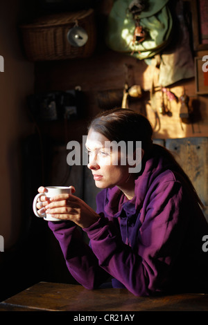 Woman drinking cup of coffee in cafe Stock Photo