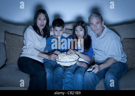 USA, California, Los Angeles, Family sitting on sofa and watching television Stock Photo