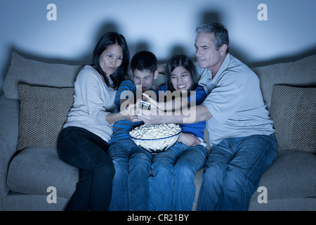 USA, California, Los Angeles, Family sitting on sofa and watching television Stock Photo