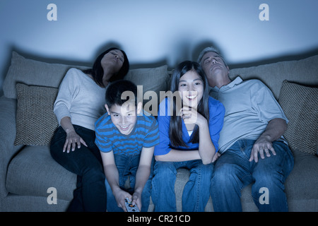 USA, California, Los Angeles, Family sitting on sofa and watching television Stock Photo