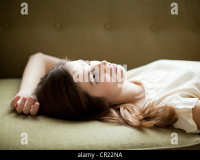 Young woman relaxing on sofa Stock Photo
