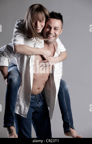 Man carrying girlfriend piggyback Stock Photo
