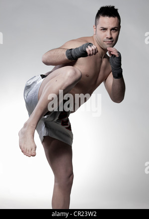 Boxer jabbing and kicking Stock Photo